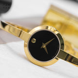 Movado Bela Black Dial Gold Steel Strap Watch For Women - 0606999 Buy Now By Movado